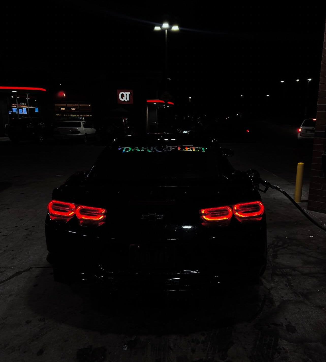 Car with illuminated taillights in a dark setting