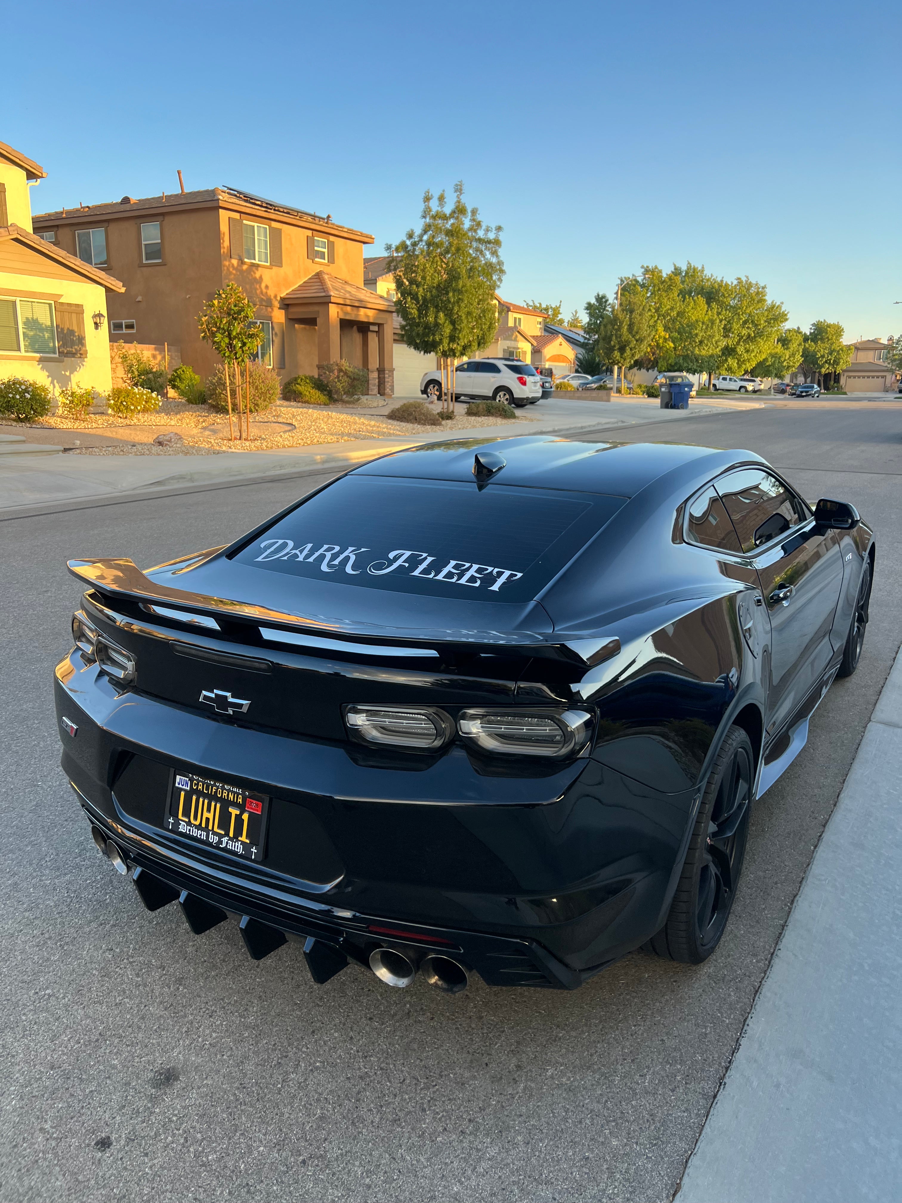 Black Chevrolet car with 'Dark Fleet' branding on a residential street.