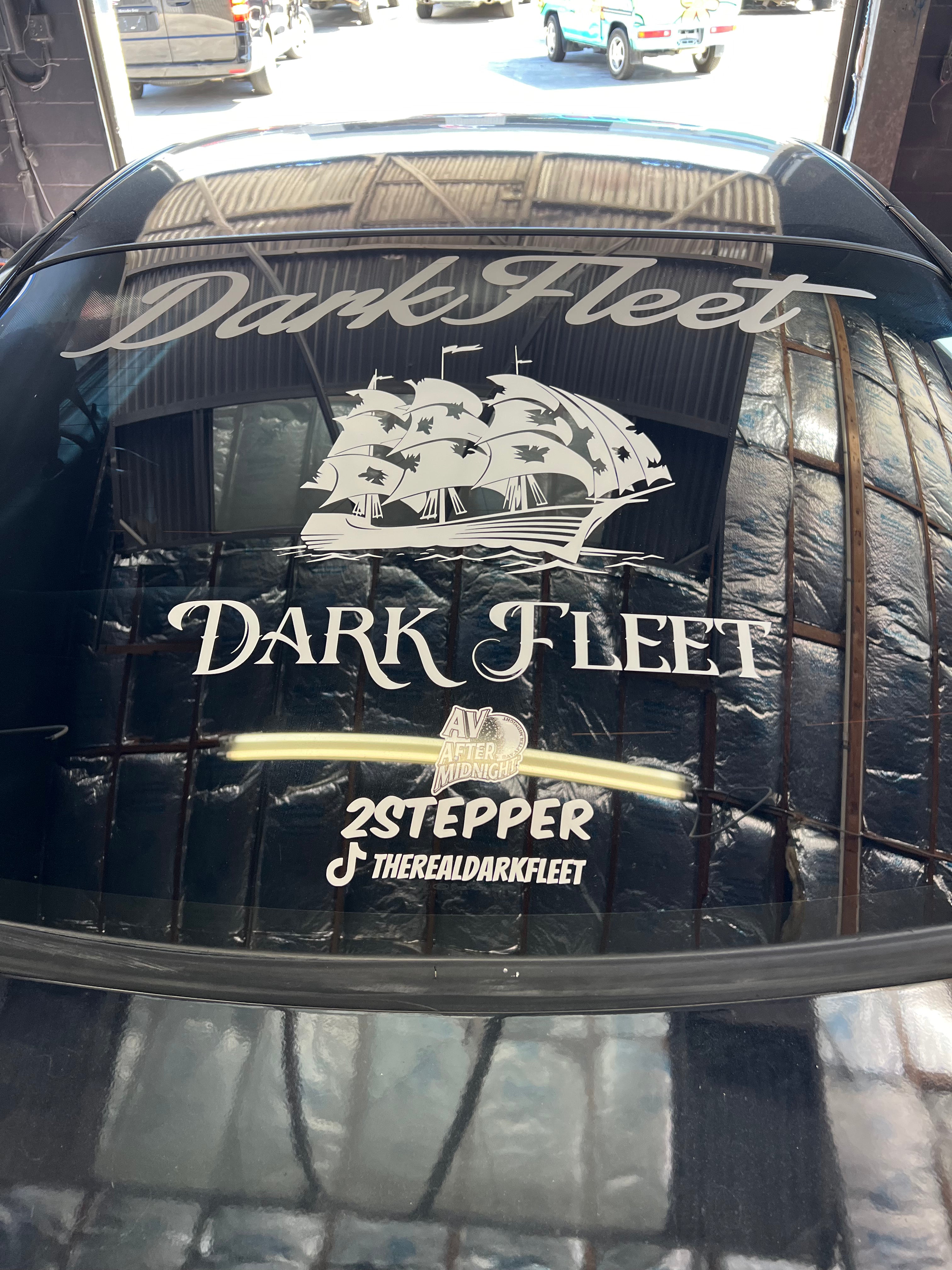 Dark Fleet logo on a car window with a ship illustration