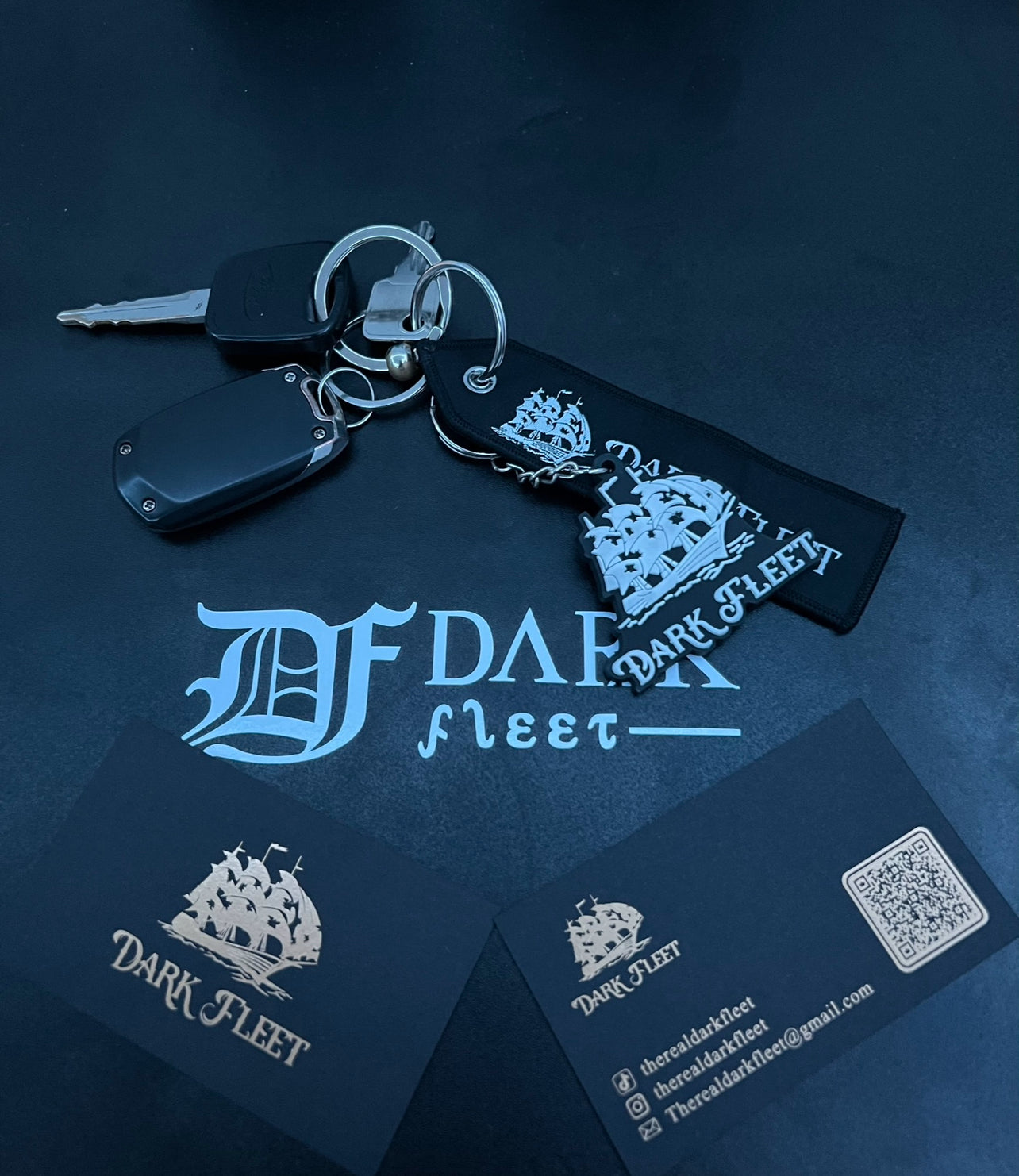 Keys with a keychain featuring 'Dark Fleet' branding on a dark blue background.